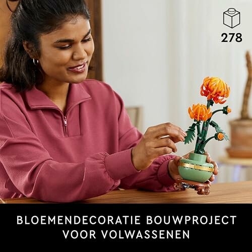 Vrouw bouwt bloemendecoratie met bouwstenen