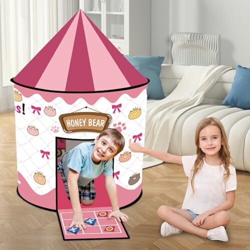 Kinderen spelen in roze speelhuisje.