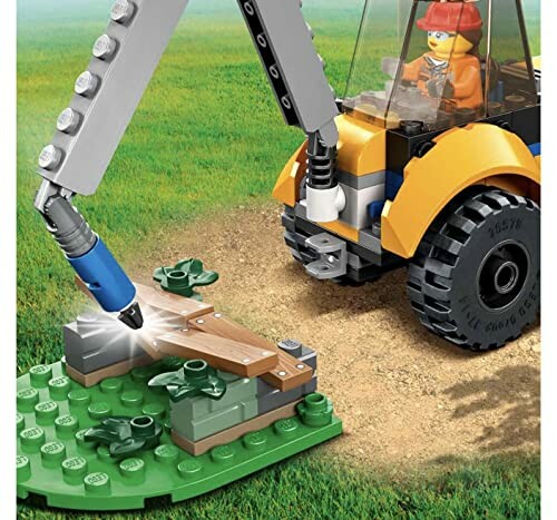 Lego graafmachine speelgoed met poppetje op grasveld